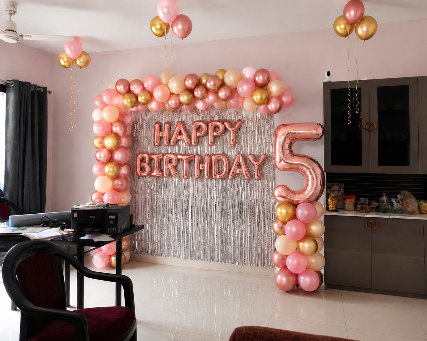 Rose gold fifth birthday home decoration setup